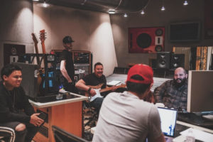 Band In Recording Studio With Producer